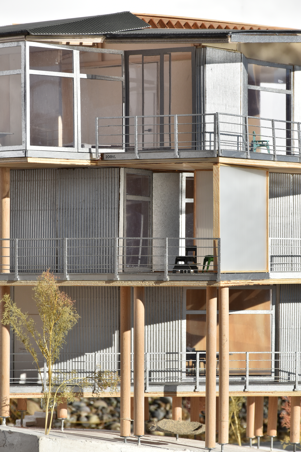 Architectural scale model of a modern residential building, emphasizing its exposed timber structure, potentially inspired by designs like Herzog & de Meuron's balconies or a Hybrid Wooden House, showcasing sustainable material use.