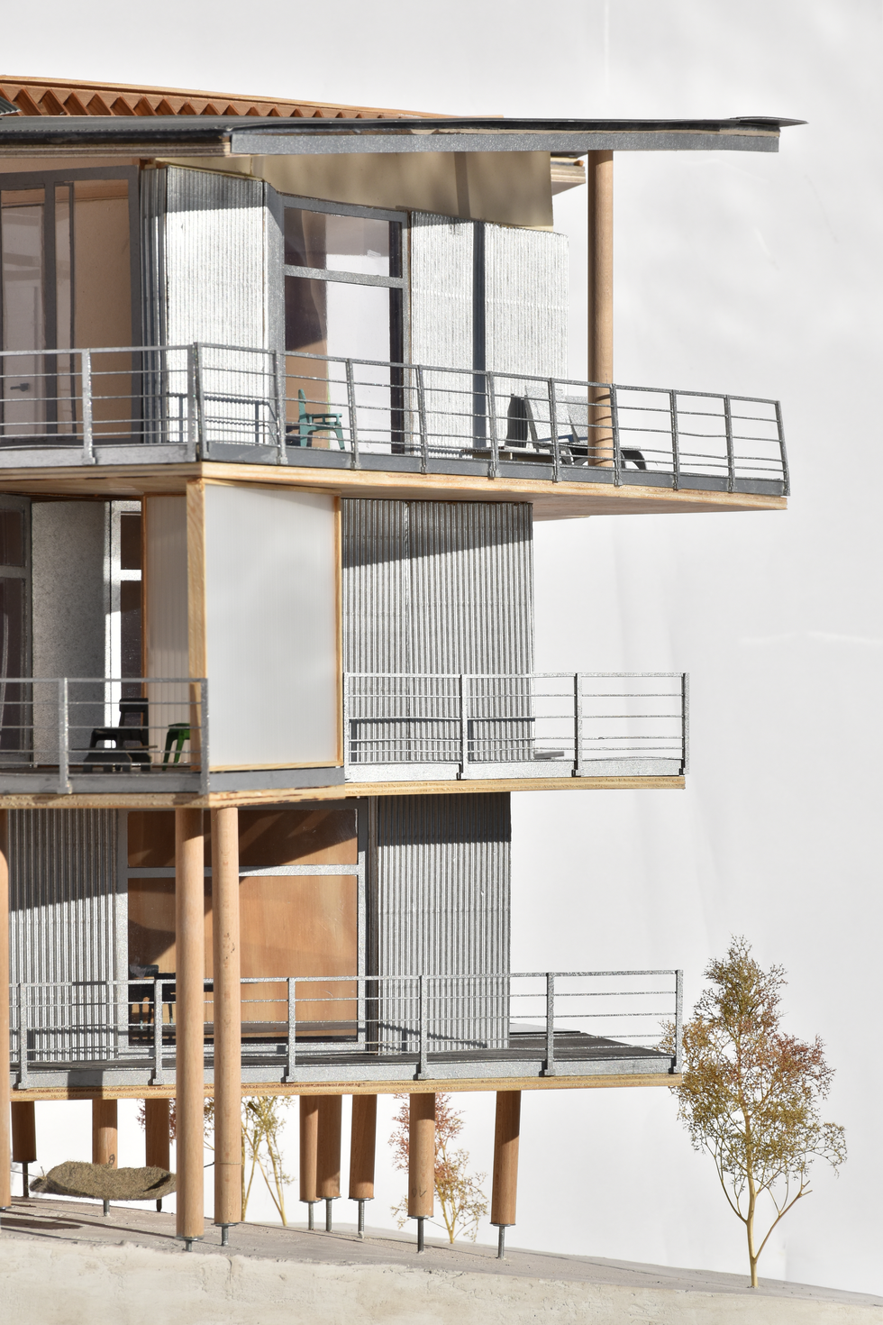 Detailed architectural model of a multi-level residential building, focusing on its timber frame structure and the design of its balconies, possibly reflecting elements seen in Herzog & de Meuron's balcony designs.