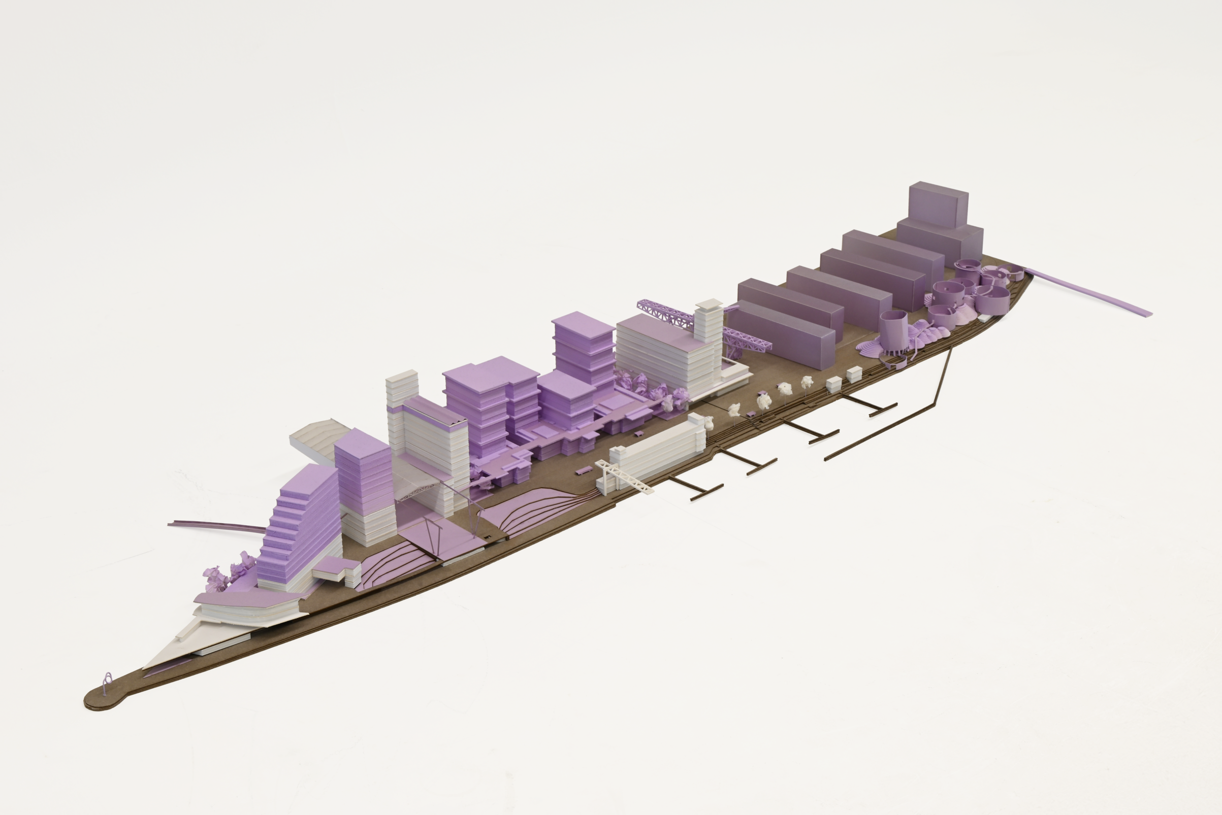Architectural model made of white foam, cardboard, and paper, featuring purple accents indicating new architectural interventions or features within the overall urban design.